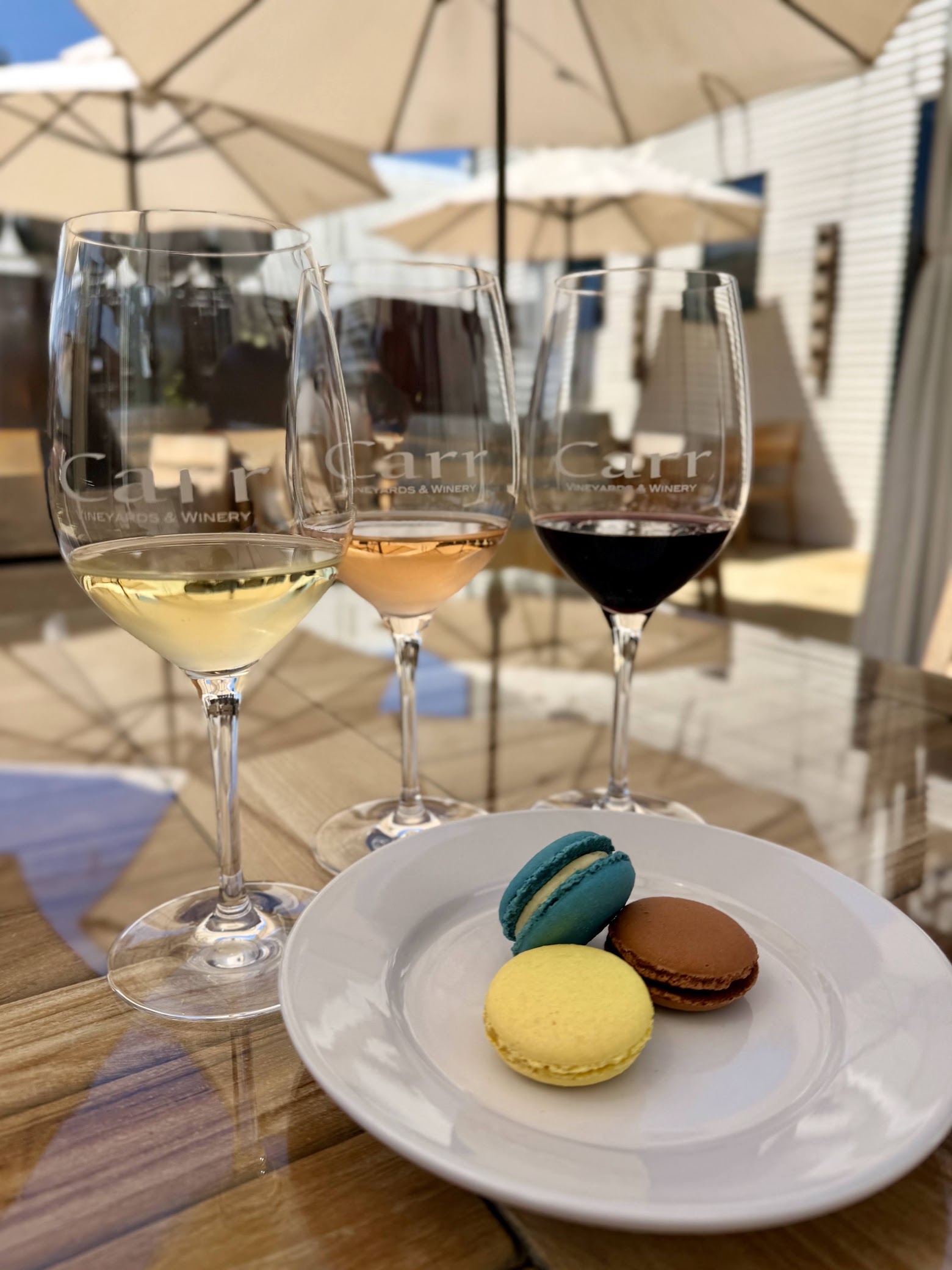 Three glasses of wine and three artisanal macarons at Carr Winery